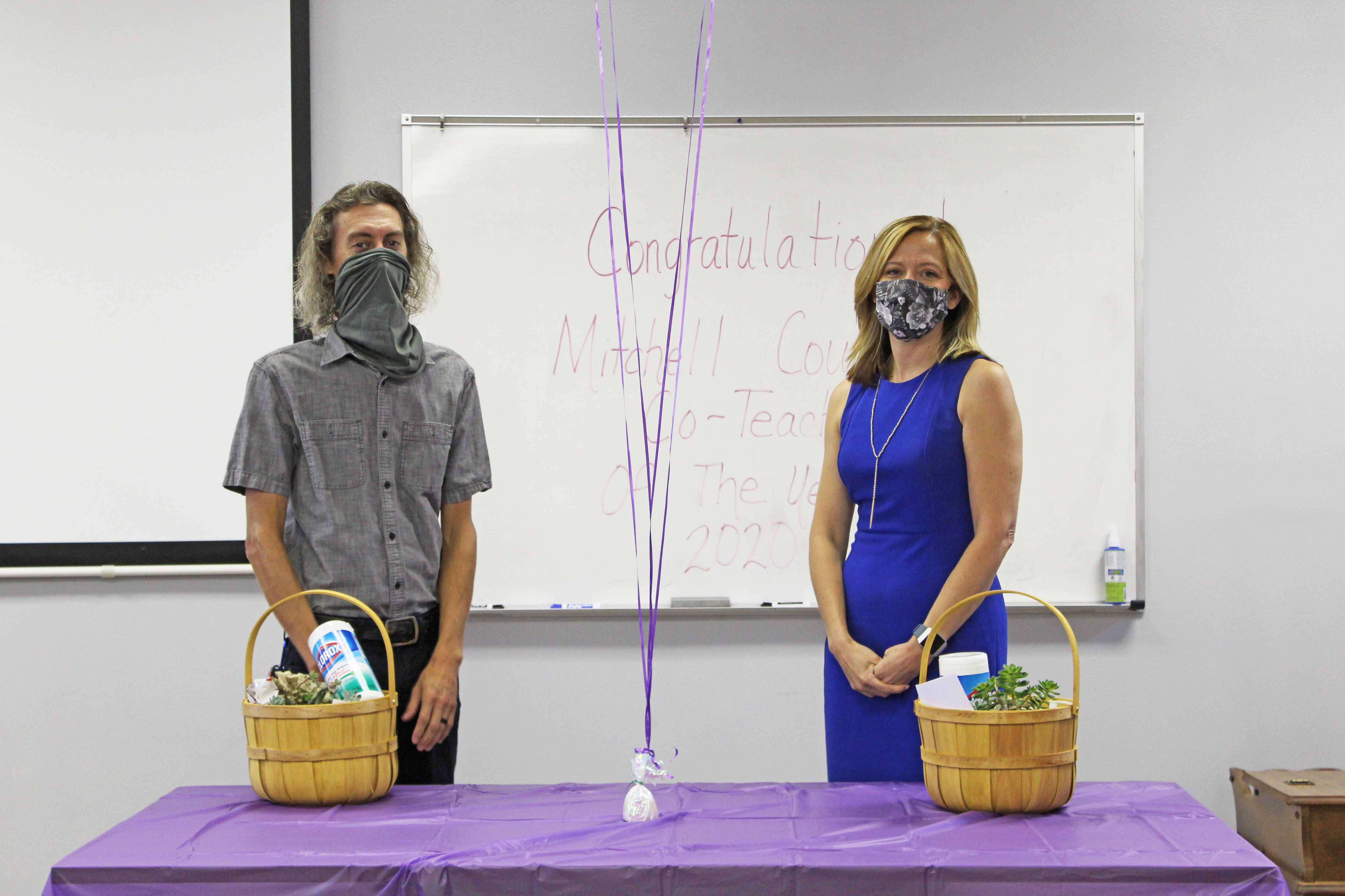 Co-teachers of the year Justin Hollifield and Michelle Lord stand masked and distanced while being recognized for their accomplishments Friday, Aug. 21 at the Mitchell County Schools Central Office. Hollifield will represent the county at the state level in January. (MNJ photo/Juliana Walker)