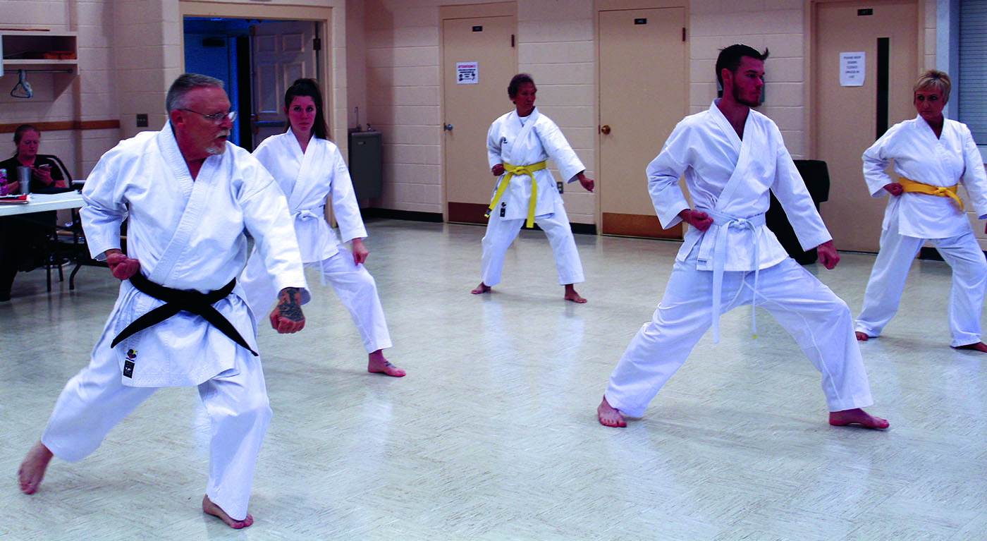 Martial artist David Lucas (left) leads a trio of fellow students during a group phase of a martial arts class at Spruce Pine First Baptist Church. Classes are open to all experience levels. (MNJ photo/Cory Spiers) 
