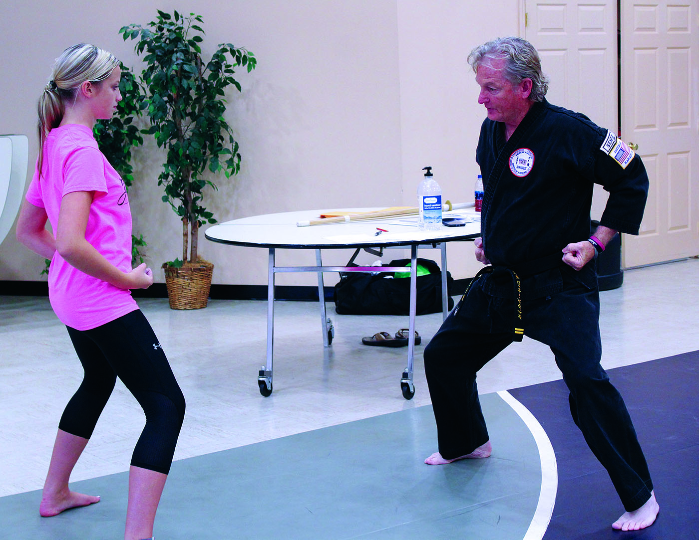 Spruce Pine First Baptist Church Pastor and Karate Instructor Rocky Branch demonstrates proper technique as Kayleigh Hollifield watches and tries her best to replicate it. Branch teaches a karate class at the church twice per week. The class is open to all ages and skill levels. Classes cost $1 and consist of instruction from Branch with help from other experienced martial artists. (MNJ photo/Cory Spiers)
