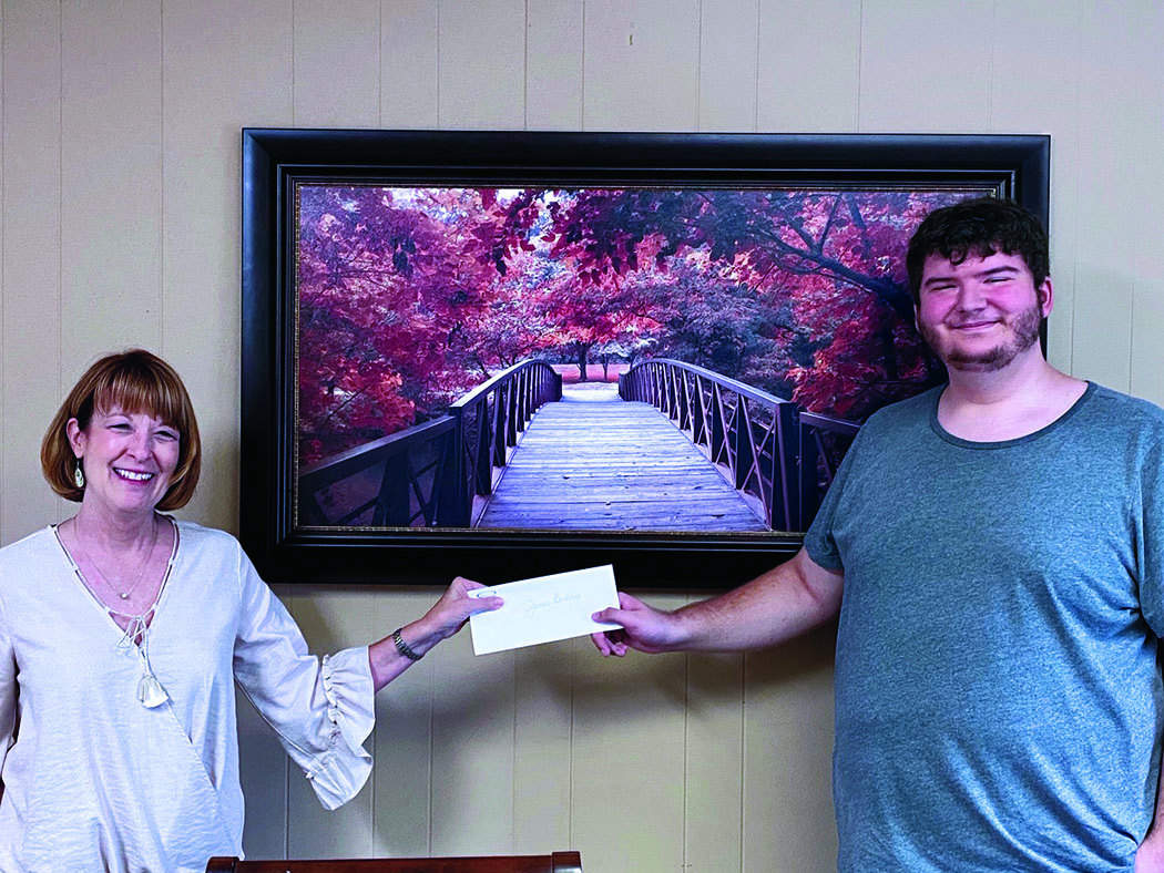 State Employees Association of North Carolina Scholarship Committee Member Rhonda Robinson presents James Biddix with his scholarship check. Biddix, a Mitchell High School graduate, was awarded $2,000-worth of scholarships from SEANC. (Submitted photo)