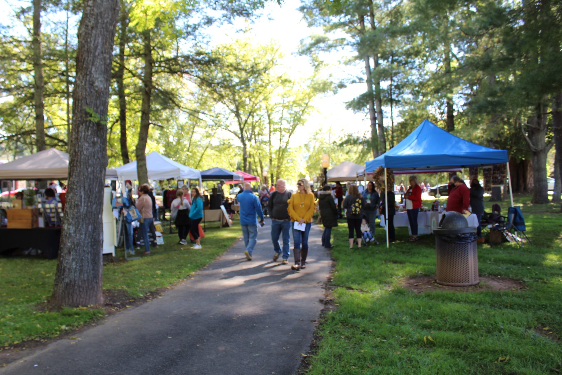 Mountaineer Festival attendees saunter down the Bakersville Creek Walk to visit some of the more than 40 featured vendors. (MNJ photo/Cory Spiers) 