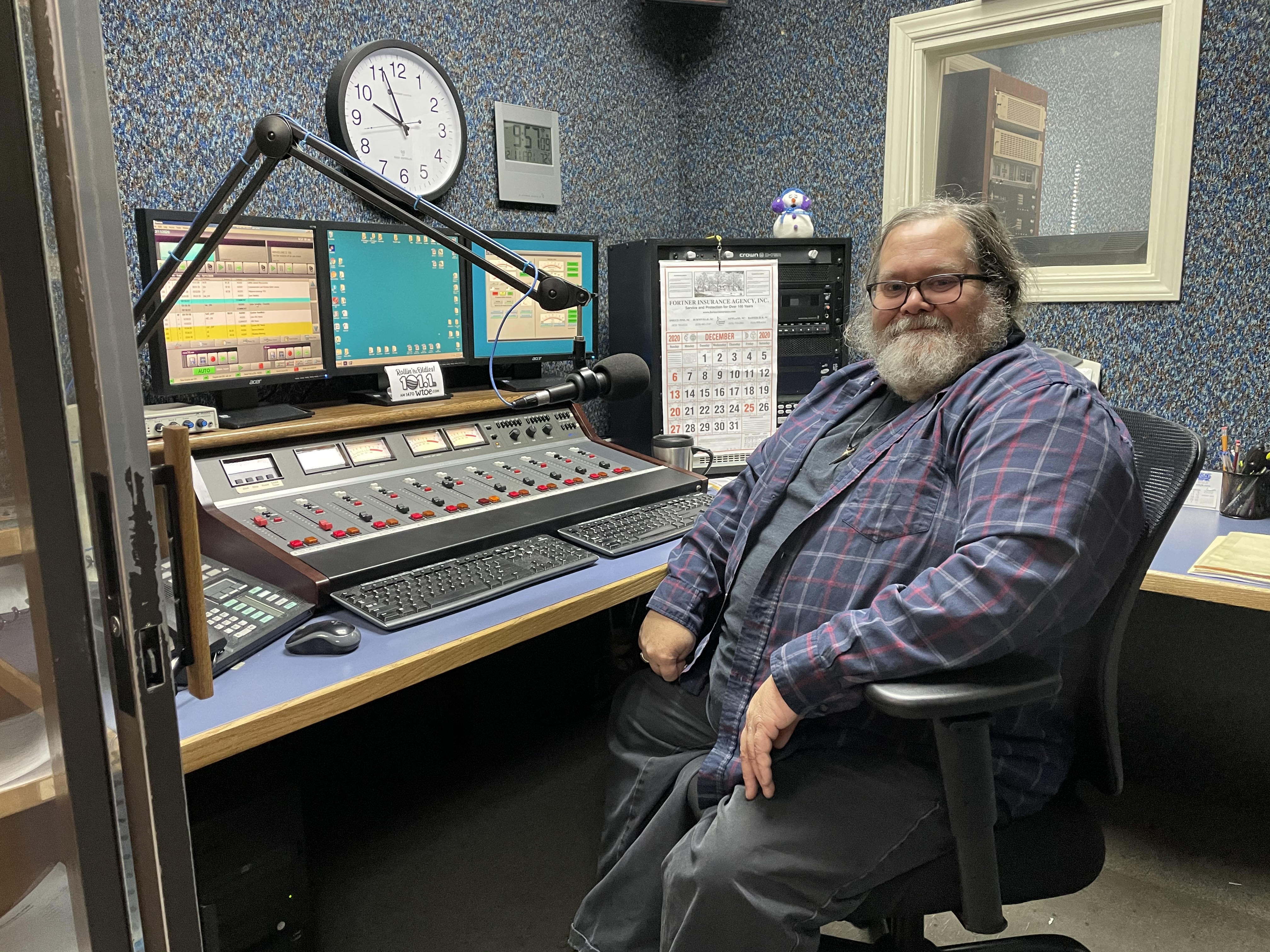 Bruce Ikard, who has served as the primary announcer for WTOE for the majority of the past four decades, sits in the WTOE control room during a normal day in the office. WTOE recently added an FM station in an effort to expand its coverage to more people in the region.  (MNJ photo/Juliana Walker)