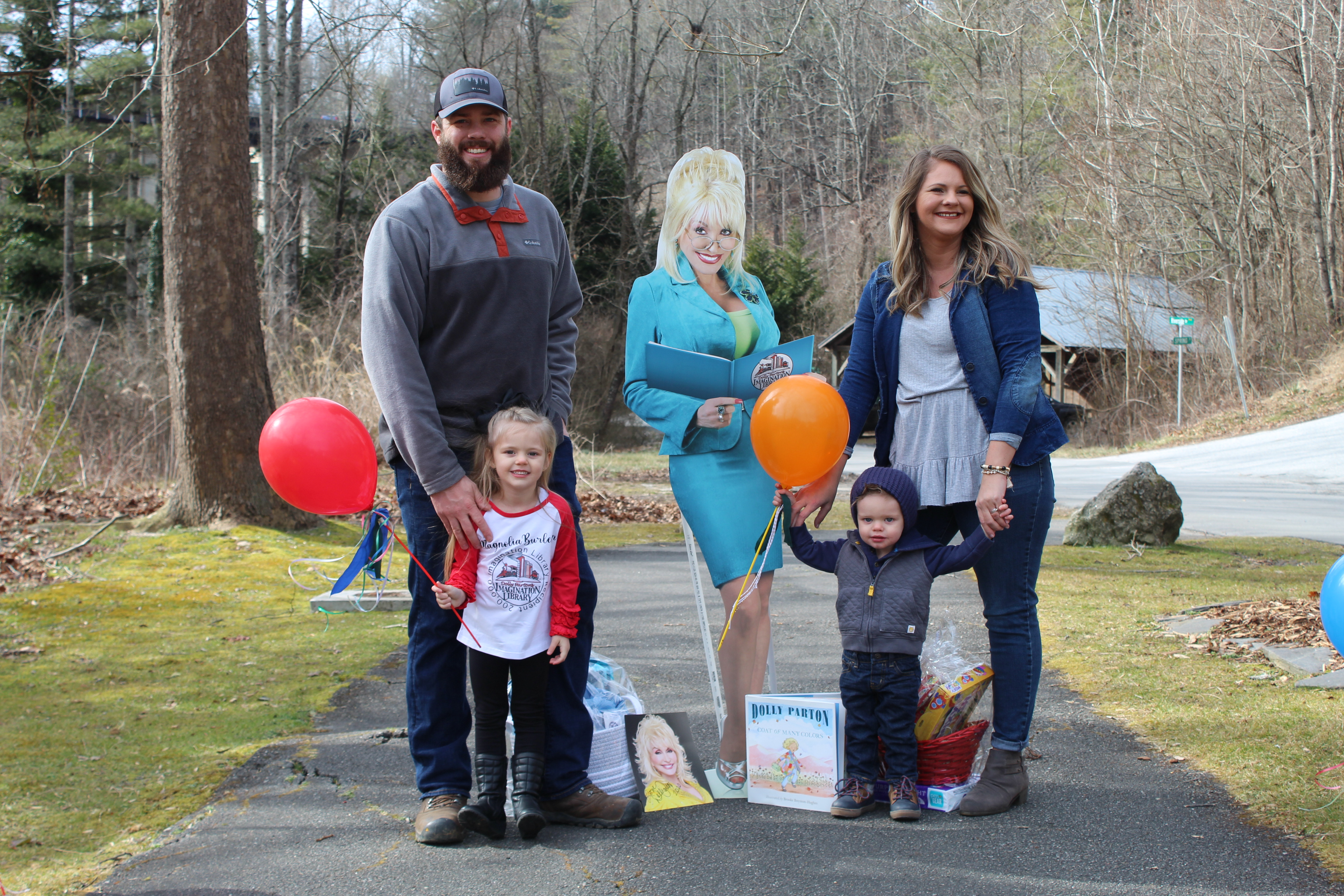 Magnolia Burleson poses for a group photo in Riverside Park with the Dolly Parton cut-out, her parents Hogan and Brandi Burleson and her brother, Memphis. (MNJ Photo/Juliana Walker)