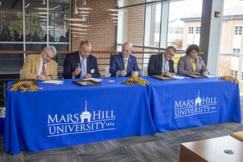 The Local Lion Promise guarantees scholarships covering at least half the price of tuition for students from Buncombe, Madison, Mitchell and Yancey counties. Pictured, from left, are school superintendents Tony Baldwin, of Buncombe County, and Will Hoffman, of Madison County; Mars Hill University President Tony Floyd; and school superintendents Chad Calhoun, of Mitchell County, and Kathy Amos, of Yancey County. (Submitted)