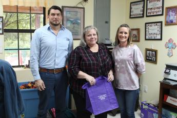 Mitchell County Department of Social Services Program Director Shawn Block, Adoption and Licensing Worker Donna Davis and Hollifield’s Christian Child Care Center Director Donna Woody pose for a photo with one of the purple tote bags the children’s center donated to DSS. The tote bags will go to children in DSS custody so they don’t have to move their belongings in trash bags when they move to a new home. (MNJ photo/Juliana Walker) 