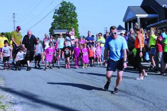 Run for Holland Organizer Adam Burleson takes off and leads the children’s portion of the annual Run for Holland charity race in this file photo from 2019. The annual event was originally delayed until Sept. 19 and has now moved into a virtual format due to the ongoing pandemic. Runners will complete their treks on their own time and submit their times online. The event will still benefit the local special needs community and participants can still win prizes. (MNJ file photo)