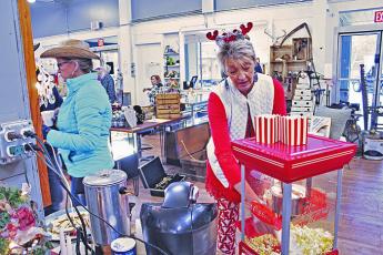 Treasures in the Pines co-owner Cheryl Buchanan prepares popcorn during last year’s Small Business Saturday in downtown Spruce Pine. This year’s event will take place completely virtually. (MNJ file photo)