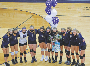 The Mitchell High School varsity volleyball team poses with its lone senior, Erika Gouge, before the start of its game against Mountain Heritage. (MNJ photo/Cory Spiers)