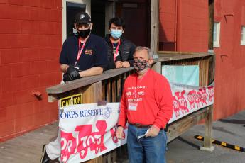 (Left to right): Mark Thomas, Coleman Taylor and Bert Nunley take a break from their distribution duties on Saturday, Dec. 12 to pose for a photo outside of the Toys for Tots office. (MNJ photo/Juliana Walker)