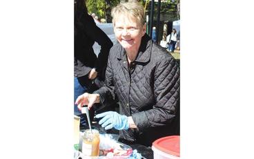 MNJ photo/Rachel Hoskins - Sue Ledford, a member of the Mitchell County Historical Society serves up samplings of apple butter with a smile during the Mountaineer & Apple Butter Festival in Bakersville. 