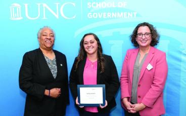 Photo/Mitchell County Government. Commissioner Harley Masters (center) is presented her certificate of completion by Tracey Johnson (left), the Immediate Past President of the North Carolina Association of County Commissioners and Aimee Wall (right), Dean of the UNC School of Government.